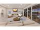 The light-filled living room features a fireplace and sliding glass doors to an outdoor patio with a lake view at 5718 Title Row Dr, Bradenton, FL 34210