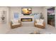 Bright living room featuring a fireplace and sliding glass doors leading to the outdoor patio area at 5718 Title Row Dr, Bradenton, FL 34210