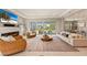 Open-concept living room with a fireplace, sliding glass doors to a patio, and modern decor at 5718 Title Row Dr, Bradenton, FL 34210