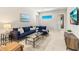 Comfortable living room featuring a plush blue sofa, stylish glass coffee table, and contemporary decor at 5718 Title Row Dr, Bradenton, FL 34210