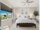 Cozy bedroom with a ceiling fan, natural light, a comfortable bed, and stylish furnishings at 5718 Title Row Dr, Bradenton, FL 34210