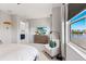 Elegant bedroom with a waterfront view, comfortable seating, and stylish decor elements at 5718 Title Row Dr, Bradenton, FL 34210