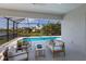 Relaxing screened-in patio with comfortable seating and views of the pool and lush backyard at 5718 Title Row Dr, Bradenton, FL 34210