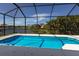 Sparkling pool within a screened enclosure offering clear blue water and scenic views at 5718 Title Row Dr, Bradenton, FL 34210