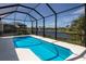 Inviting pool in screened lanai, with scenic view of the lake and neighboring houses at 5718 Title Row Dr, Bradenton, FL 34210
