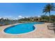 Inviting community pool with ample seating, overlooking a scenic lake and lush landscaping at 5718 Title Row Dr, Bradenton, FL 34210