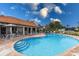 Community pool with plenty of seating, lounge chairs, and a tiled patio at 5718 Title Row Dr, Bradenton, FL 34210