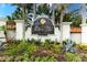 Elegant community entrance sign amid lush landscaping and palm trees at 5718 Title Row Dr, Bradenton, FL 34210