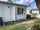Backyard featuring a concrete patio and an open door to the home's back entrance at 6110 Coral Way, Bradenton, FL 34207