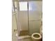 Functional bathroom featuring a walk-in shower with sliding glass doors and tiled walls at 6110 Coral Way, Bradenton, FL 34207