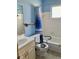 Cozy bathroom in blue with shower and accessibility features like grab bars at 6110 Coral Way, Bradenton, FL 34207