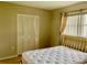 Bedroom with neutral walls, closet, window with blinds and drapes and a queen-sized bed at 6110 Coral Way, Bradenton, FL 34207