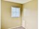 Neutral bedroom featuring carpet flooring and a window with vertical blinds for natural light at 6110 Coral Way, Bradenton, FL 34207