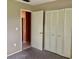 Bedroom featuring an open doorway and bi-fold closet doors at 6110 Coral Way, Bradenton, FL 34207