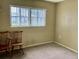 Clean bedroom with neutral paint and carpet, with window and pair of chairs at 6110 Coral Way, Bradenton, FL 34207