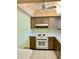 Functional kitchen with laminate countertops, white appliances, and wood cabinetry at 6110 Coral Way, Bradenton, FL 34207