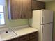 Kitchen with white refrigerator, laminate counters, sink, and wood cabinets at 6110 Coral Way, Bradenton, FL 34207
