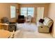 Comfortable living room with cozy seating, neutral carpet, and natural light from the windows at 6110 Coral Way, Bradenton, FL 34207