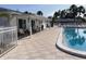 Community pool with lounge chairs, tables, and covered seating areas for residents to enjoy at 6110 Coral Way, Bradenton, FL 34207