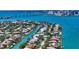 Aerial view of a waterfront neighborhood, lush landscaping, and canal access at 612 Mourning Dove Dr, Sarasota, FL 34236