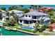 Stunning aerial view of a luxurious waterfront estate with a beautiful pool at 612 Mourning Dove Dr, Sarasota, FL 34236