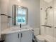 Bathroom featuring glass shower, stylish vanity, and view of tropical palm trees at 612 Mourning Dove Dr, Sarasota, FL 34236