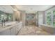 This bathroom features a soaking tub, marble floors, and a luxurious, spacious glass-enclosed shower at 612 Mourning Dove Dr, Sarasota, FL 34236