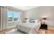 Bedroom with large window, a light gray color scheme and modern décor accents at 612 Mourning Dove Dr, Sarasota, FL 34236