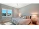 Bedroom featuring a window overlooking palm trees, and decor in muted, complementary colors at 612 Mourning Dove Dr, Sarasota, FL 34236