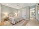 Bright bedroom features neutral tones, a ceiling fan, and an ensuite bathroom entrance at 612 Mourning Dove Dr, Sarasota, FL 34236