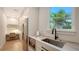 Bright butler's pantry features stainless steel appliances, custom cabinets, and a built-in desk at 612 Mourning Dove Dr, Sarasota, FL 34236