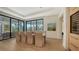 Elegant dining room with large windows, tray ceilings, and designer touches at 612 Mourning Dove Dr, Sarasota, FL 34236
