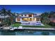 Stunning waterfront home featuring a private dock, sparkling pool, and lush landscaping at 612 Mourning Dove Dr, Sarasota, FL 34236