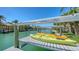 Dock showing kayak lift with kayaks suspended over tranquil canal waters at 612 Mourning Dove Dr, Sarasota, FL 34236