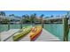 Colorful kayaks resting on a private dock with waterfront views at 612 Mourning Dove Dr, Sarasota, FL 34236