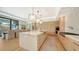Open kitchen with a marble-top island, pendant lighting, and wooden cabinets at 612 Mourning Dove Dr, Sarasota, FL 34236