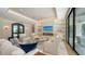 Bright living room featuring a fireplace, TV, modern decor, and glass sliding doors at 612 Mourning Dove Dr, Sarasota, FL 34236