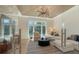 Cozy living room with high ceilings, a statement chandelier, and serene waterfront views at 612 Mourning Dove Dr, Sarasota, FL 34236
