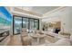 Elegant living room featuring a fireplace, high ceilings, and doors to outdoor entertainment area at 612 Mourning Dove Dr, Sarasota, FL 34236