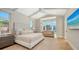 Serene bedroom with vaulted ceilings, water views, and a comfortable seating area at 612 Mourning Dove Dr, Sarasota, FL 34236