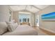 Bright main bedroom with a high ceiling, a waterfront view, and a flat-screen TV at 612 Mourning Dove Dr, Sarasota, FL 34236