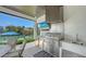 Outdoor kitchen with a grill, sink, and views of the waterway at 612 Mourning Dove Dr, Sarasota, FL 34236