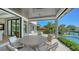 Inviting patio with dining area, overlooking the pool and landscaped yard at 612 Mourning Dove Dr, Sarasota, FL 34236