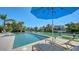 Relaxing poolside scene with a blue umbrella and waterfront views at 612 Mourning Dove Dr, Sarasota, FL 34236