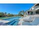 Beautiful waterfront pool with an integrated spa and comfortable lounge chairs at 612 Mourning Dove Dr, Sarasota, FL 34236