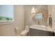 Chic powder room with a decorative mirror, pendant light, and a vessel sink at 612 Mourning Dove Dr, Sarasota, FL 34236