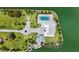 Luxury home aerial showcasing an expansive lawn, waterfront access, a boat, and a stunning pool area for elevated living at 630 De Narvaez Dr, Longboat Key, FL 34228
