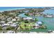 Stunning aerial view showcasing the property's prime waterfront location and proximity to the area's beaches at 630 De Narvaez Dr, Longboat Key, FL 34228