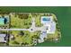 Aerial view of home featuring lush landscaping and an in-ground pool at 630 De Narvaez Dr, Longboat Key, FL 34228