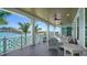 Inviting outdoor balcony offering picturesque water views, ceiling fans, and comfortable seating at 630 De Narvaez Dr, Longboat Key, FL 34228
